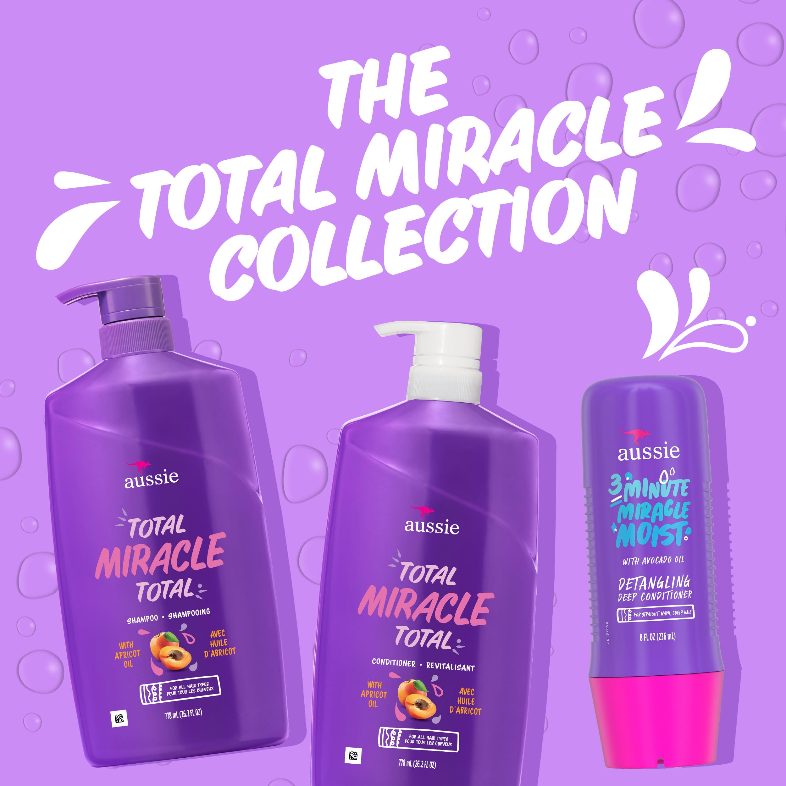 Hand holding bottles for scale showing large 26.2 fl oz Aussie sizes