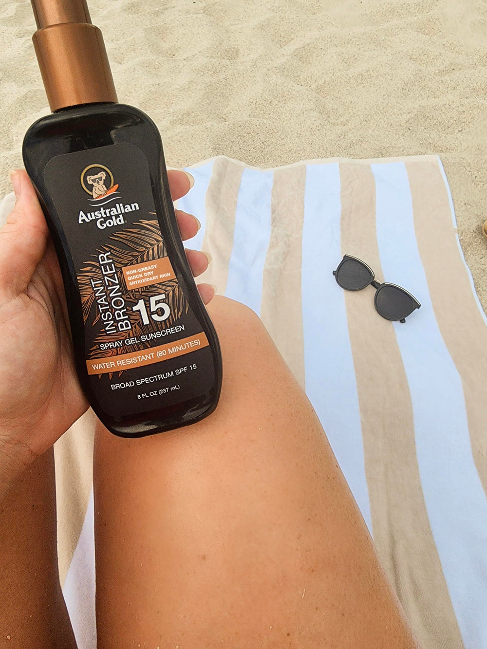 Australian Gold bottle tucked in a beach bag showing travel-ready convenience