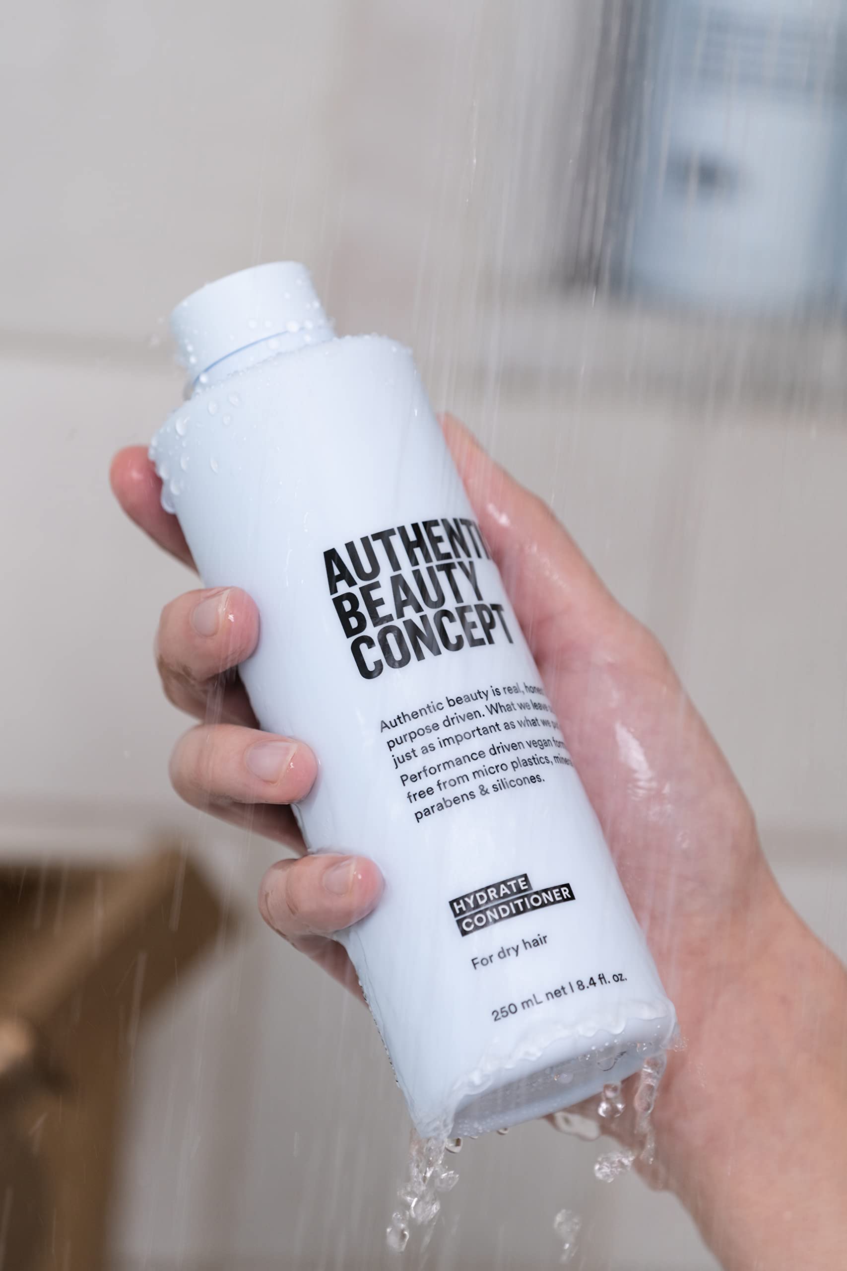 Authentic Beauty Concept conditioner applied to wet hair, detangling benefit visible