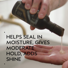 AVEDA liquid texture pouring from nozzle demonstrates lightweight spreadability and shine