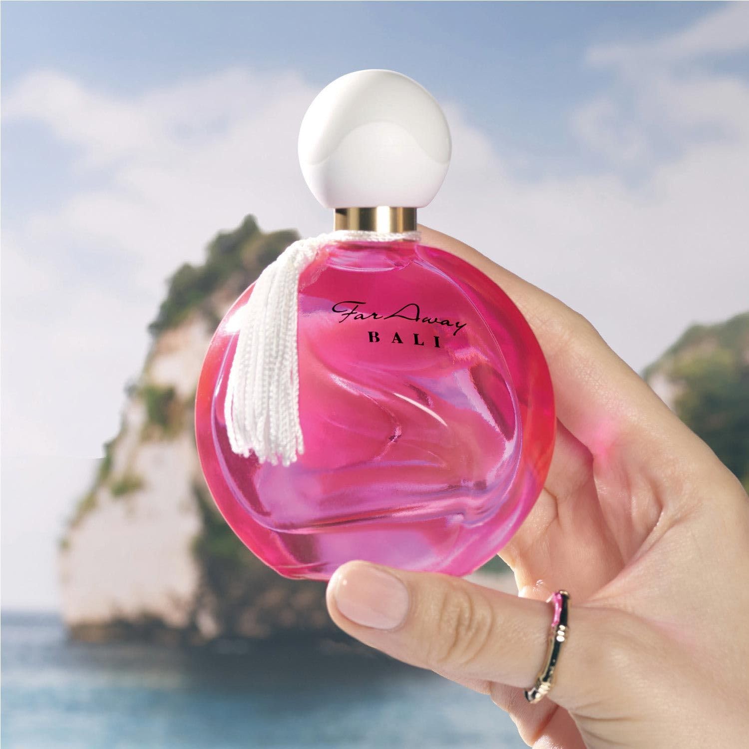AVON bottle held next to a hand showing 50 ml scale benefit portable size