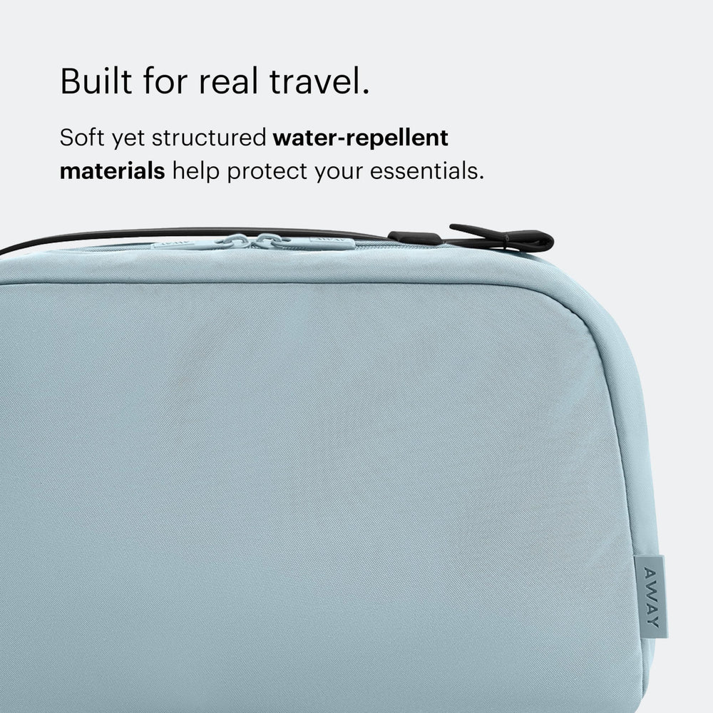 Away toiletry bag elastic toothbrush loop and exterior zip pocket for quick access
