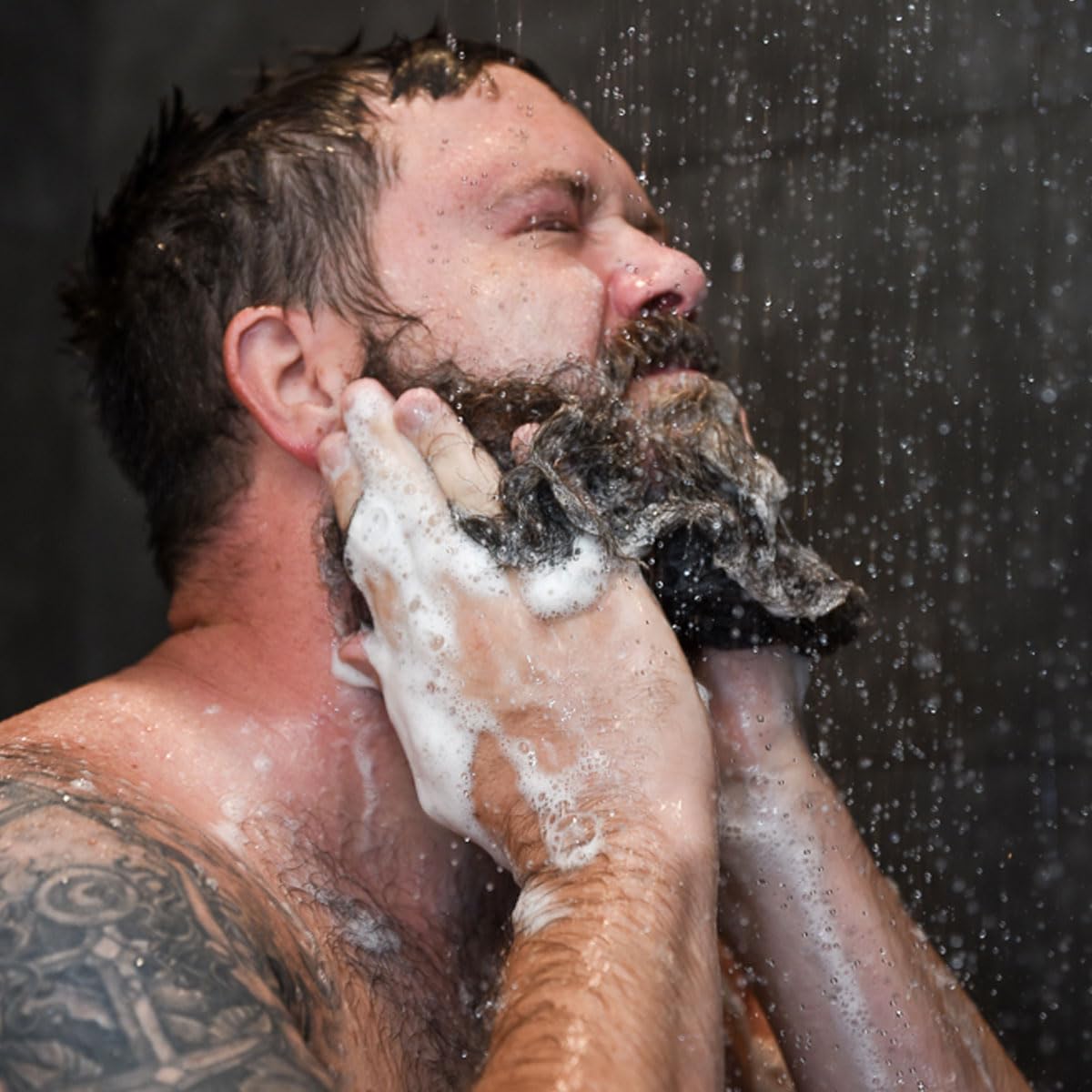 Badass Beard Care bottle on bathroom shelf suggesting daily grooming routine
