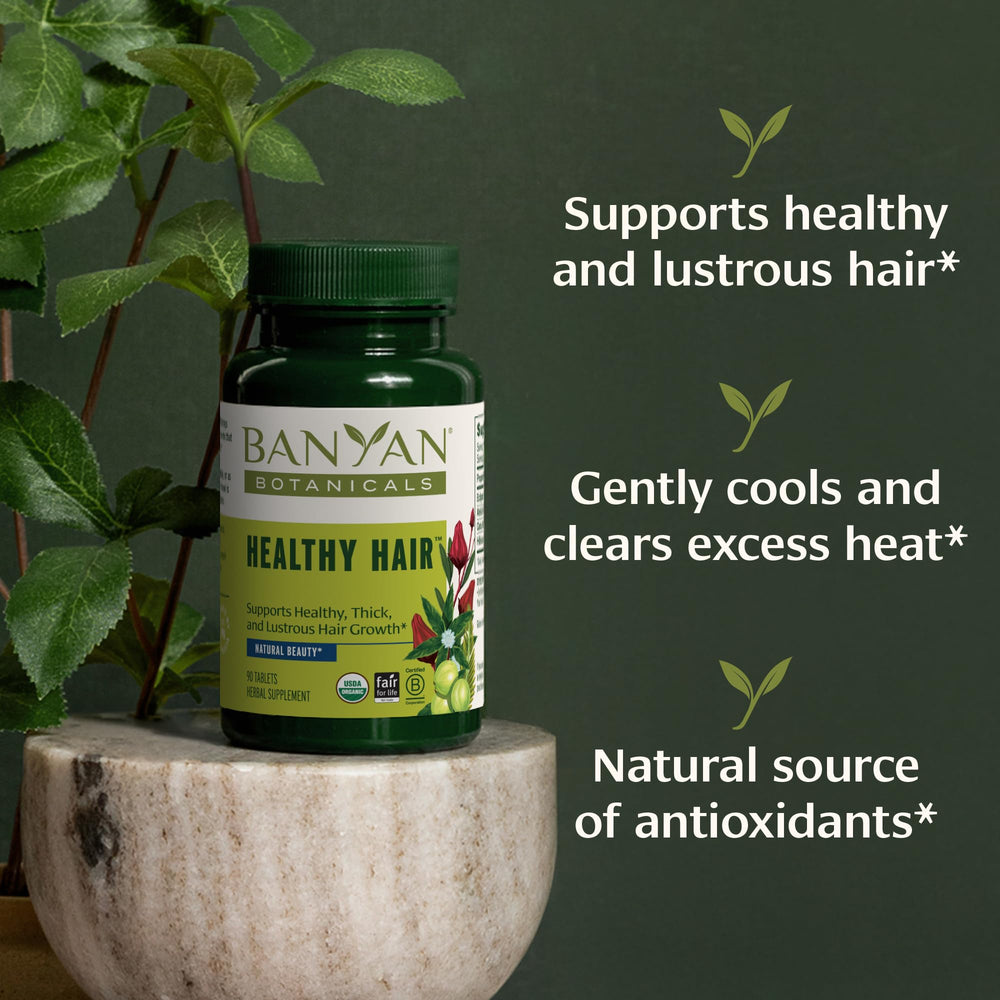 Banyan Botanicals tablets on a spoon ready for daily supplement routine