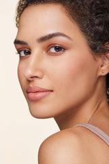 bareMinerals spoolie blending product on eyebrow for natural seamless finish