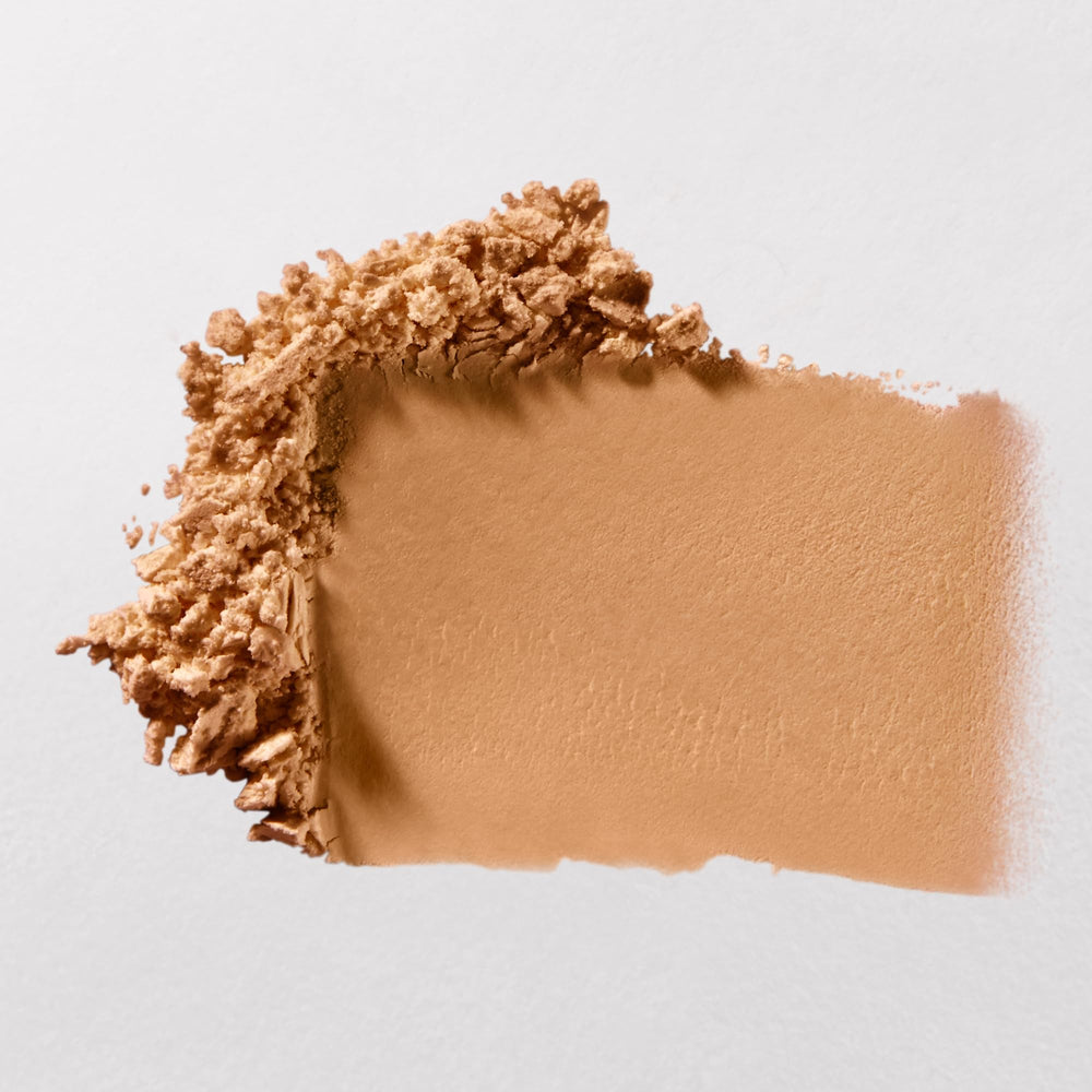 bareMinerals powder applied with brush on hand demonstrating mattifying effect and easy blending