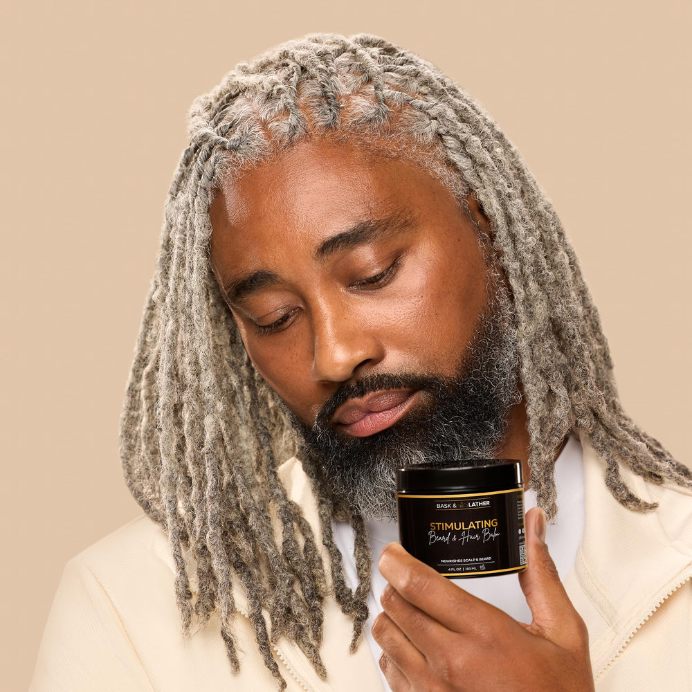 BASK & LATHER balm on fingers showing easy spreadability and precise application benefit