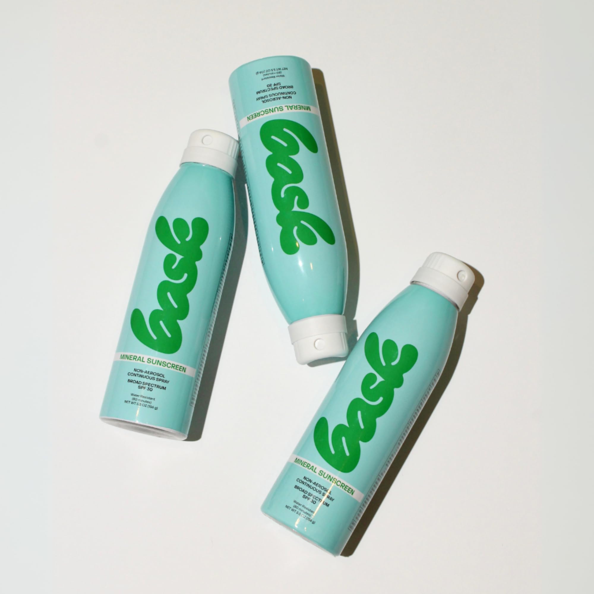 Bask sunscreen spray used outdoors at the beach for reef-safe protection