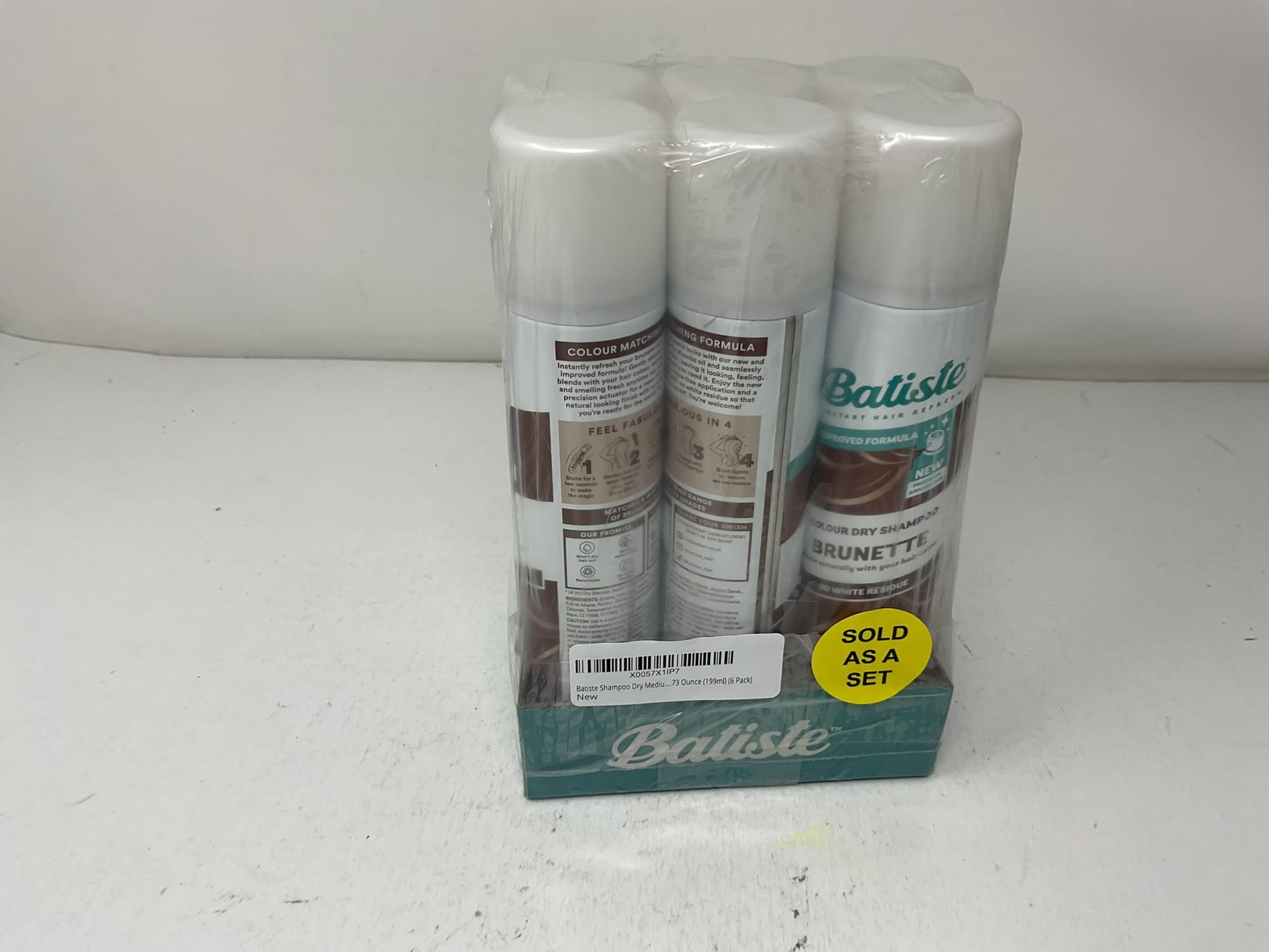 Hand holding Batiste can to show portable 6.73 oz size convenience
