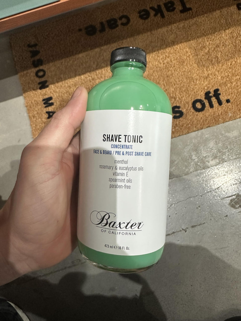 Baxter of California bottle staged with towel and razor for everyday shaving ritual
