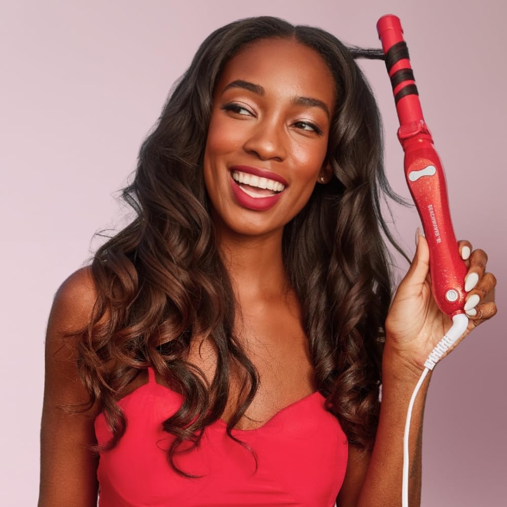Beachwaver B1 size comparison in hand demonstrating lightweight portability