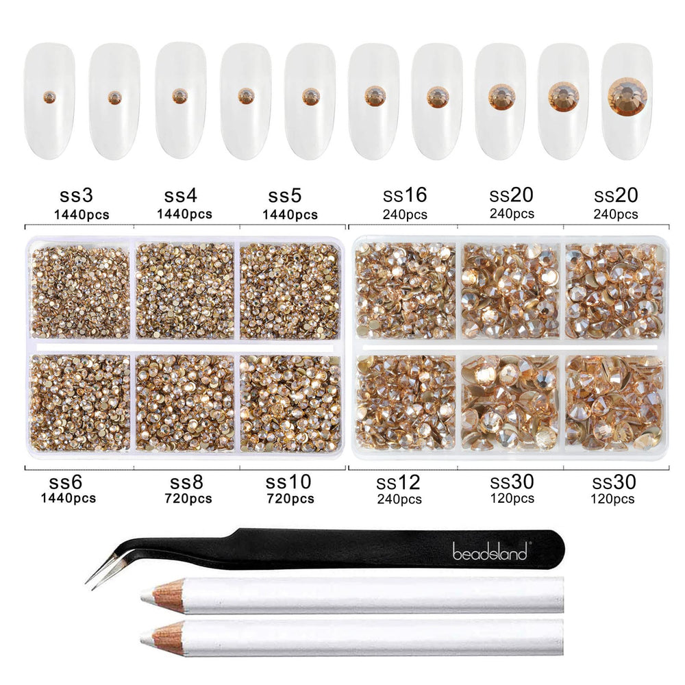 BEADSLAND wax pencils and tweezer beside scattered rhinestones for easy placement