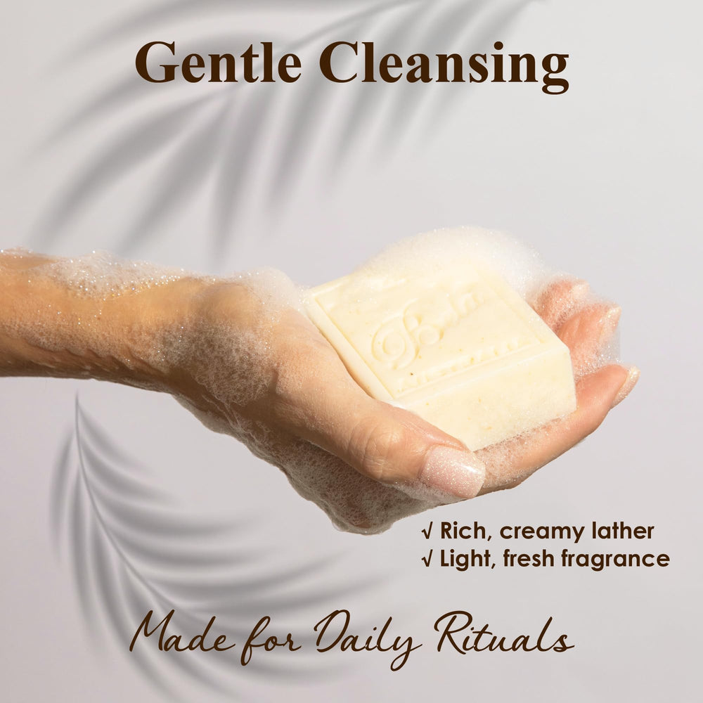 BELA soap in hand under water demonstrating gentle, non-drying cleanse