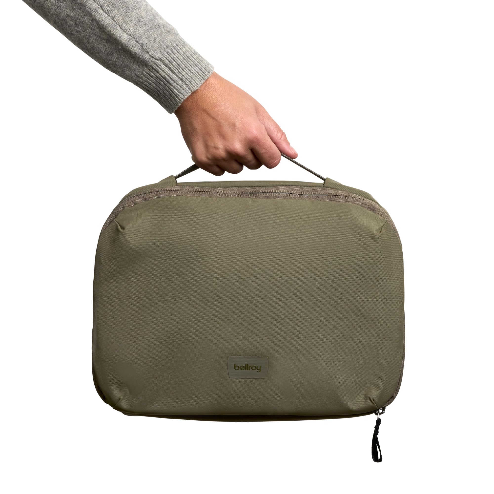 Bellroy toiletry kit beside passport and toothpaste showing travel scale