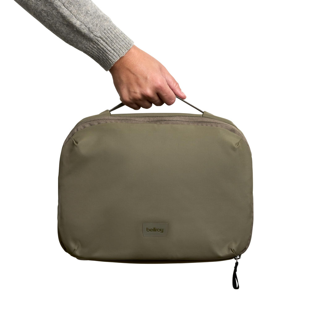 Bellroy toiletry kit beside passport and toothpaste showing travel scale