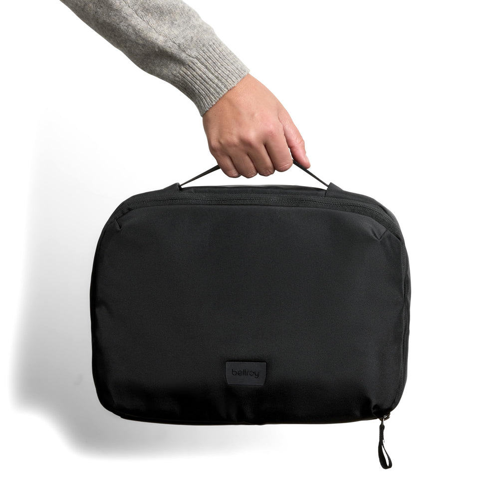 Bellroy size comparison with travel bottles demonstrating 8L capacity and compact footprint