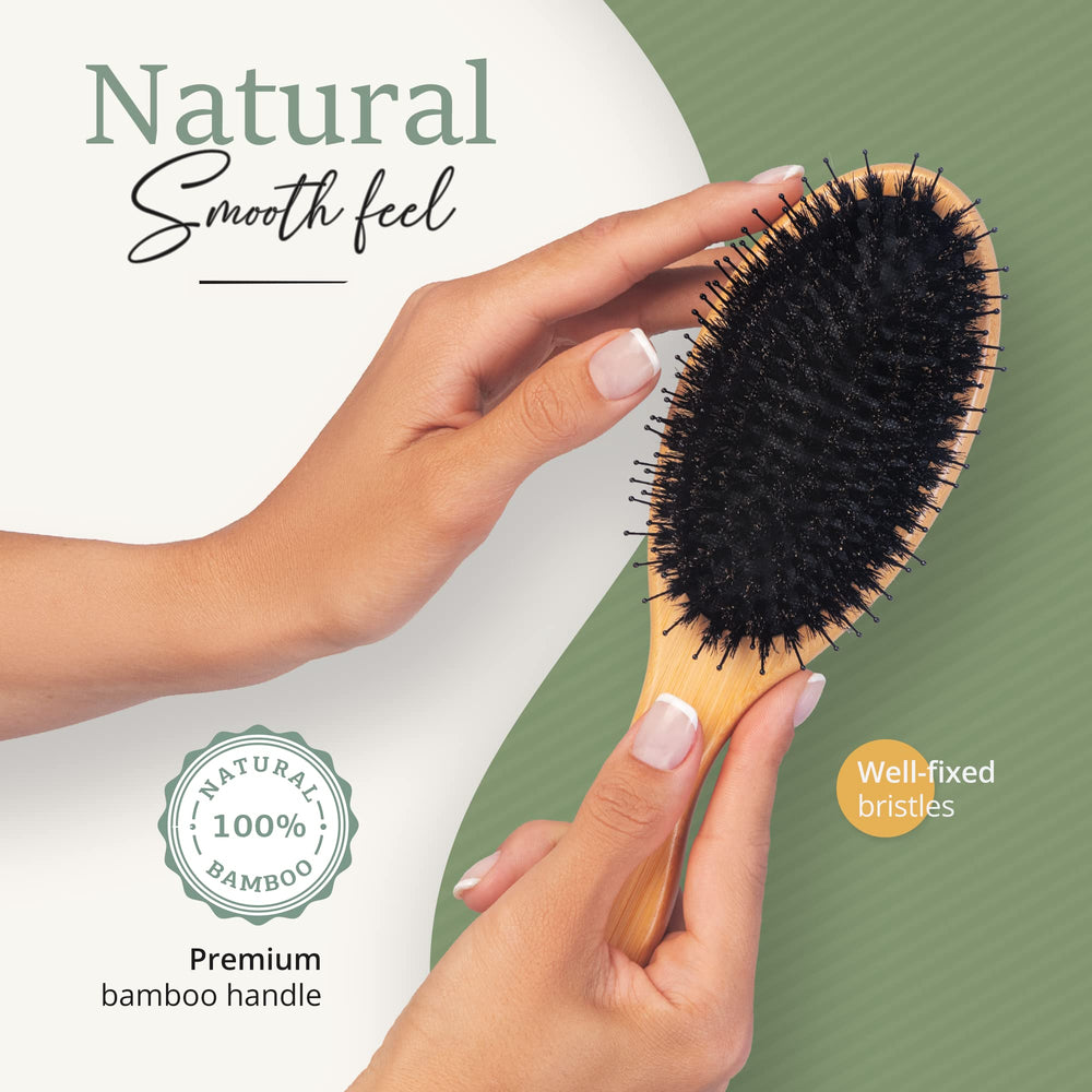 Belula brush beside hand to show large size and comfortable grip