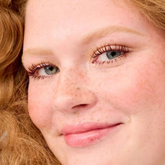 Benefit BADgal BANG lifestyle model wearing mascara showing volumized lashes benefit