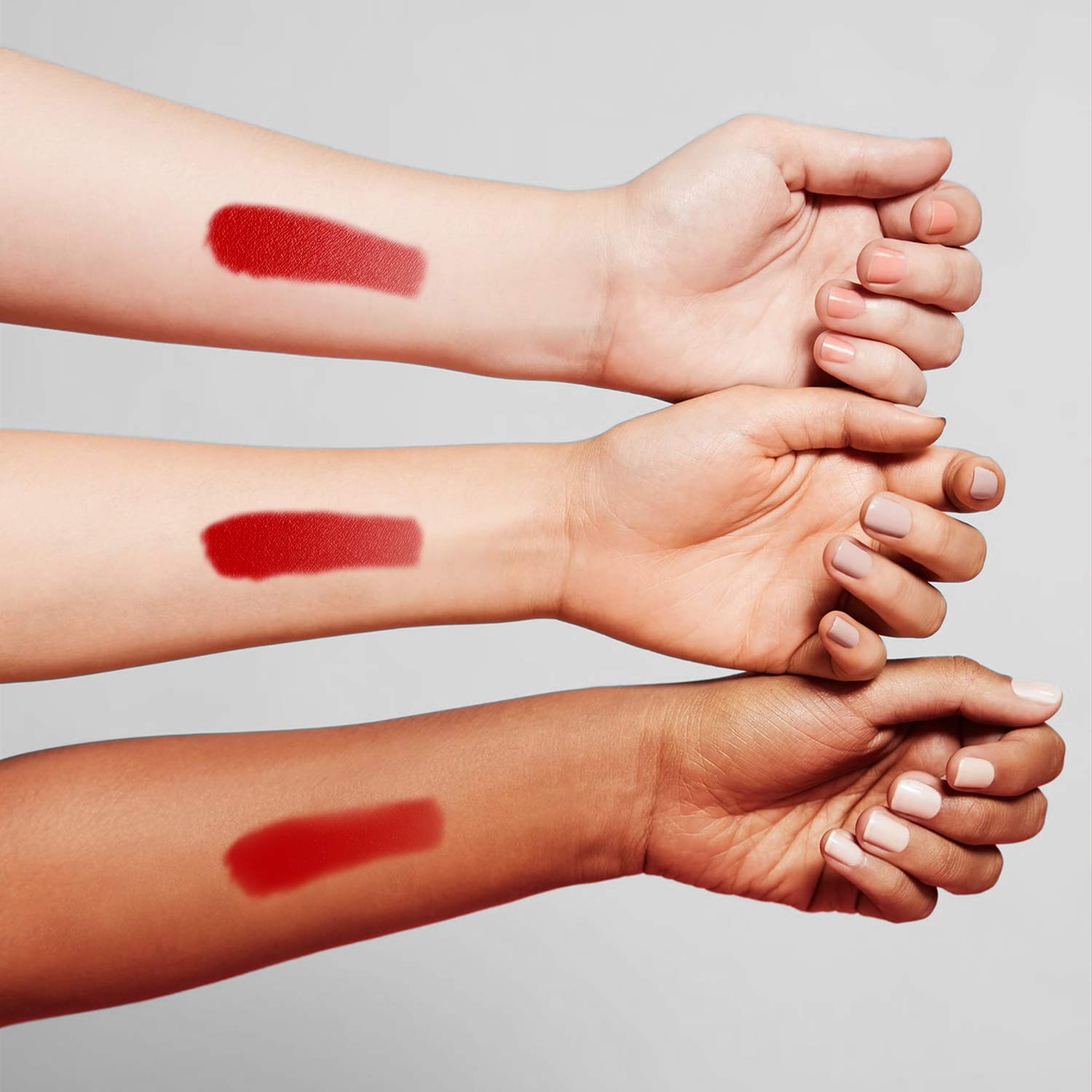 Benefit Benetint swiped on skin showing sheer rose tint and natural-looking flush benefit