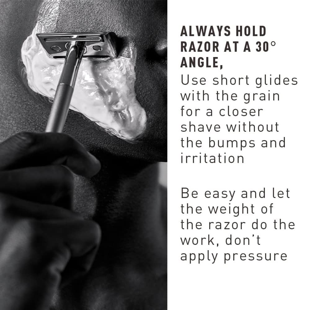 Bevel razor held in hand to show scale and ergonomic weight for steadier strokes