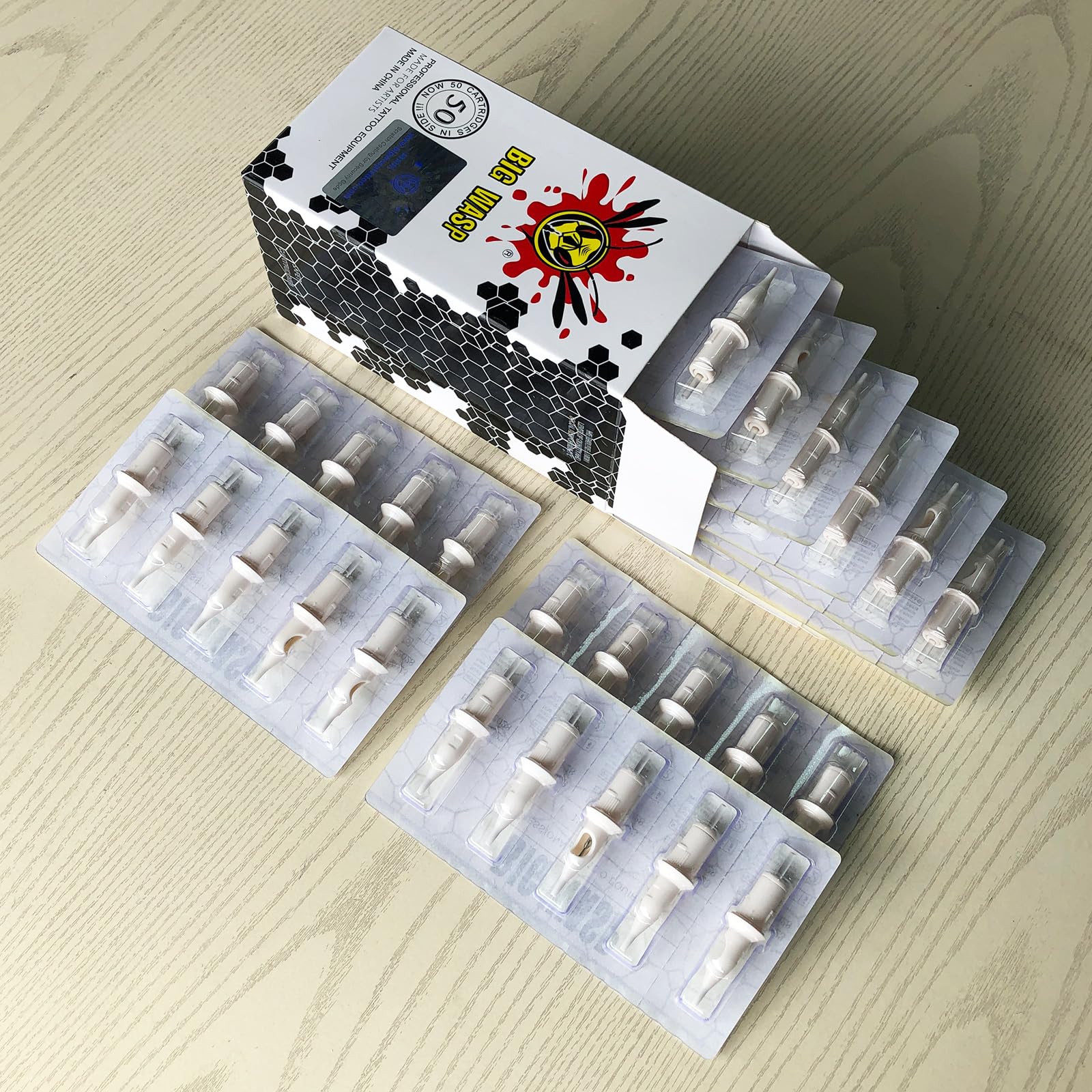 BIGWASP cartridges on a studio tray in a tattoo workspace for professional readiness
