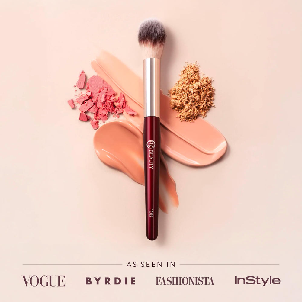BK BEAUTY brush beside fingers showing compact size for travel
