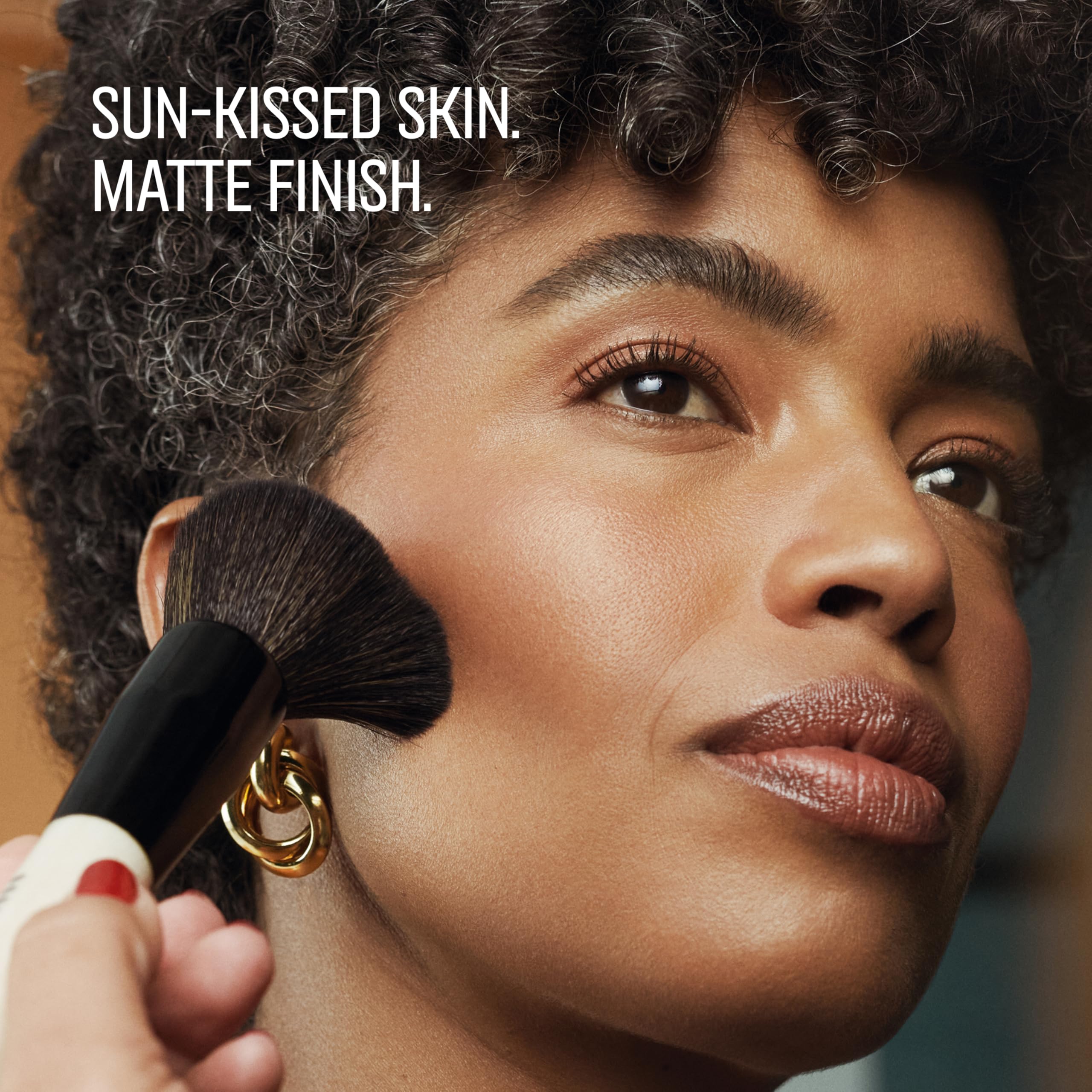 Bobbi Brown bronzing powder applied with brush demonstrating even pickup and buildable coverage benefit