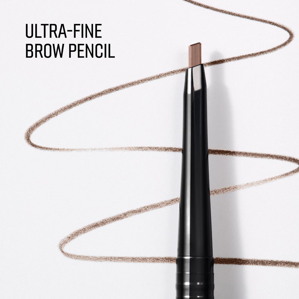Bobbi Brown pencil held in hand showing size and precise control during application