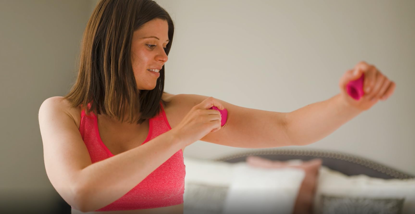 Hand holding both BodyGlide For Her sizes showing portability and value