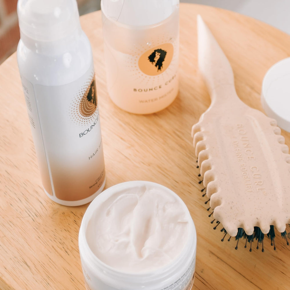 Bounce Curl cream in hand ready to apply for quick curl refresh benefits