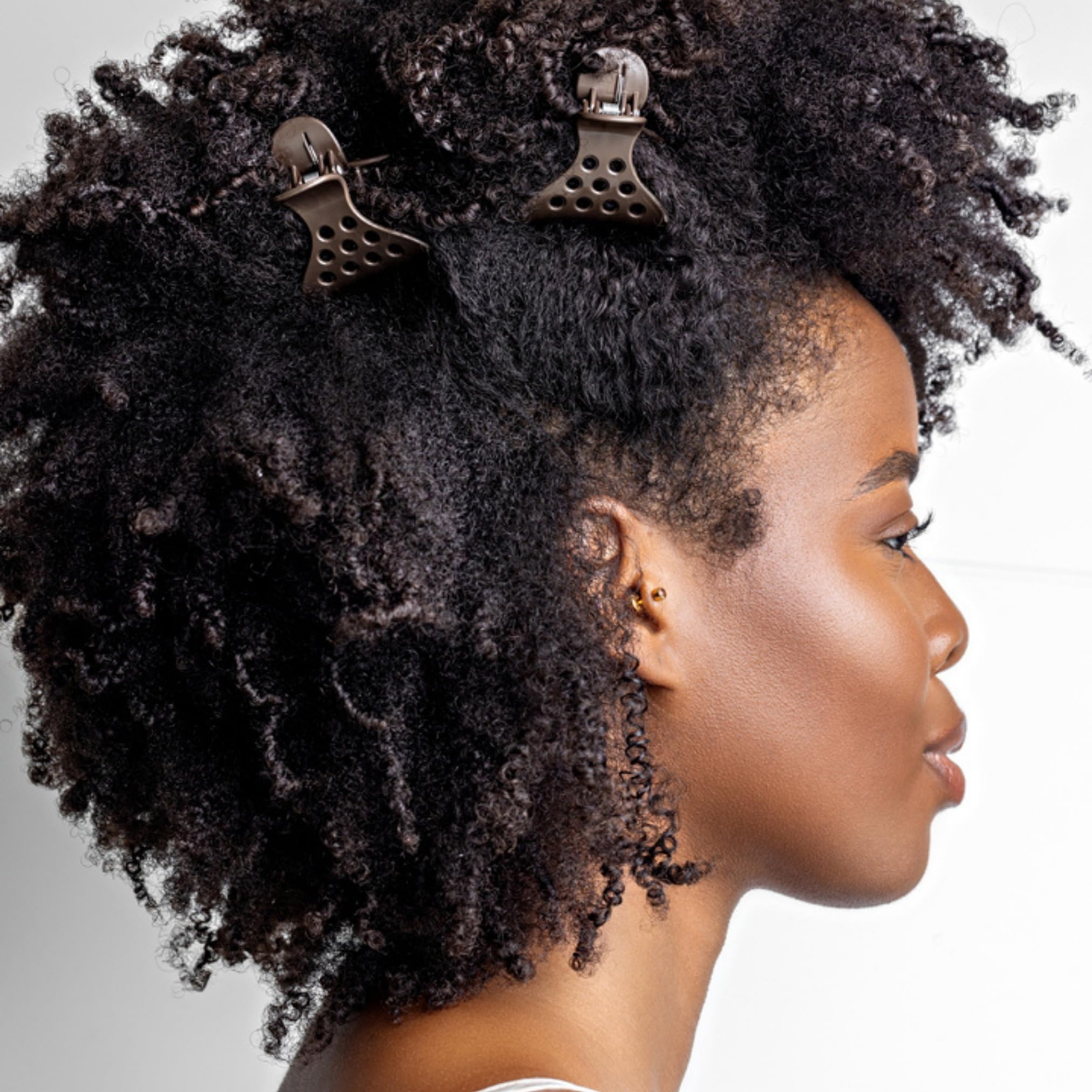 Bounce Curl clips placed on damp hair creating lifted roots benefit