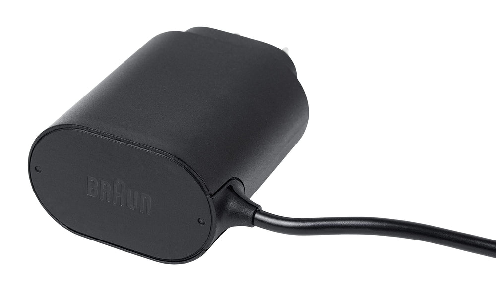 Braun charger next to shaver for scale showing size comparison benefit easy storage