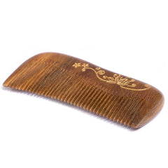 Breezelike comb held in hand to show compact size and portability