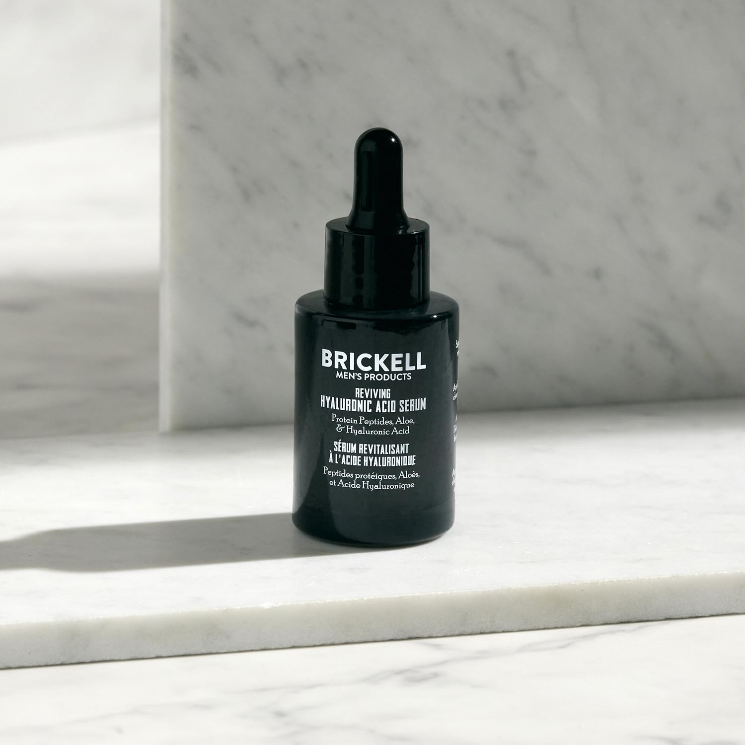 Brickell serum being applied to a hand demonstrating fast absorption benefit