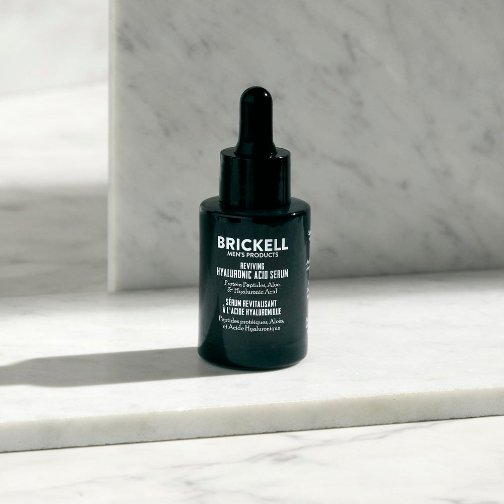 Brickell serum being applied to a hand demonstrating fast absorption benefit