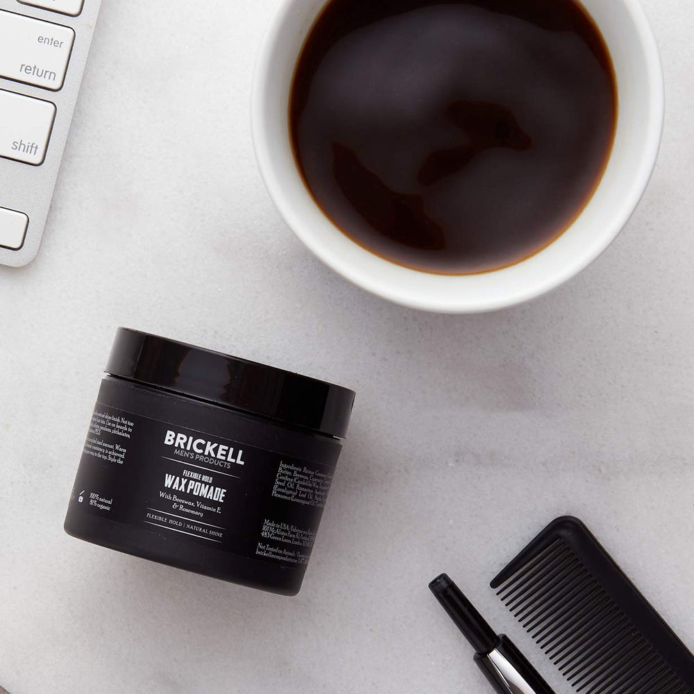 Brickell applying pomade to hands for even distribution and quick styling benefit