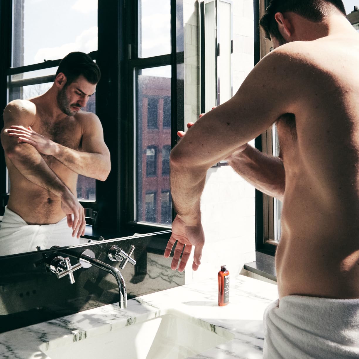 Brickell bottle beside shower for lifestyle use and daily grooming convenience