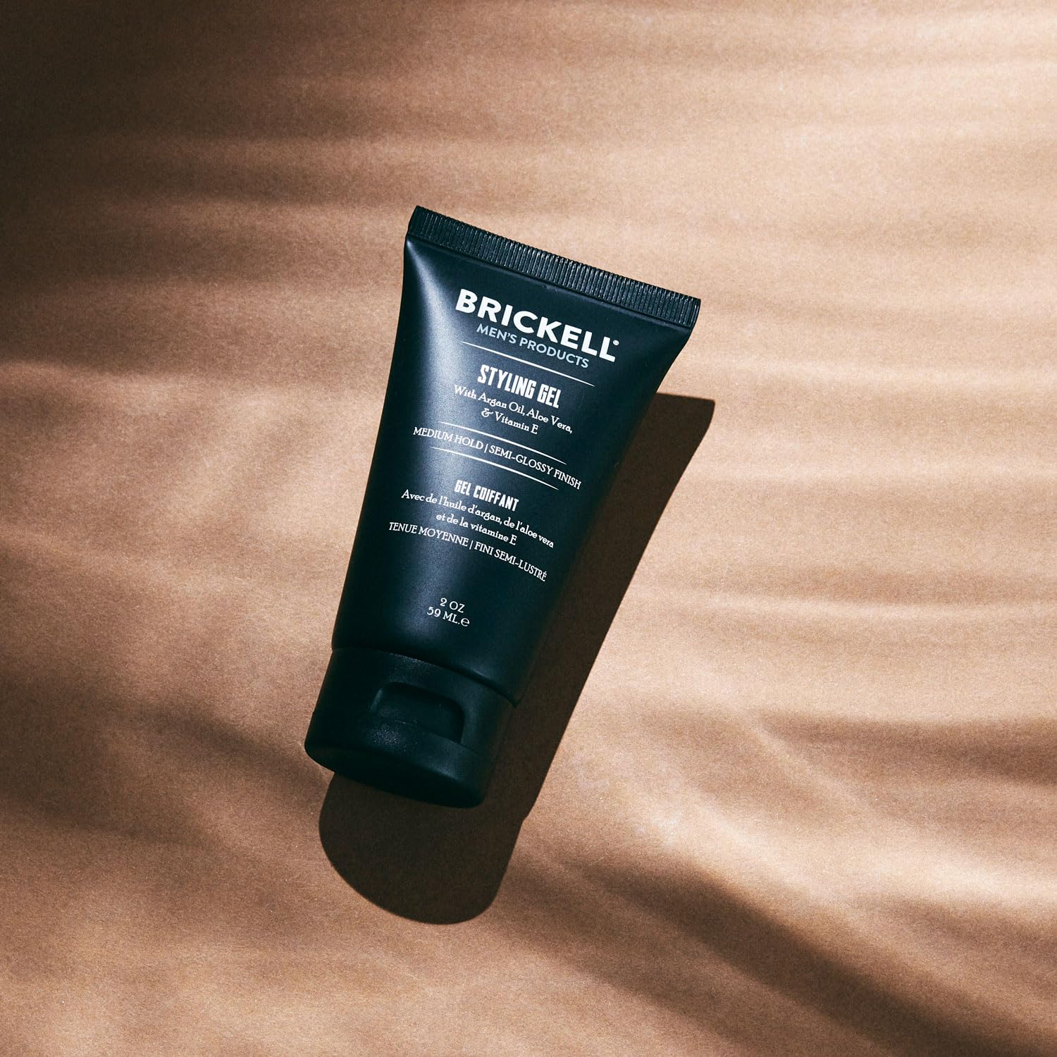 Brickell on hair in use creating defined glossy style and manageability