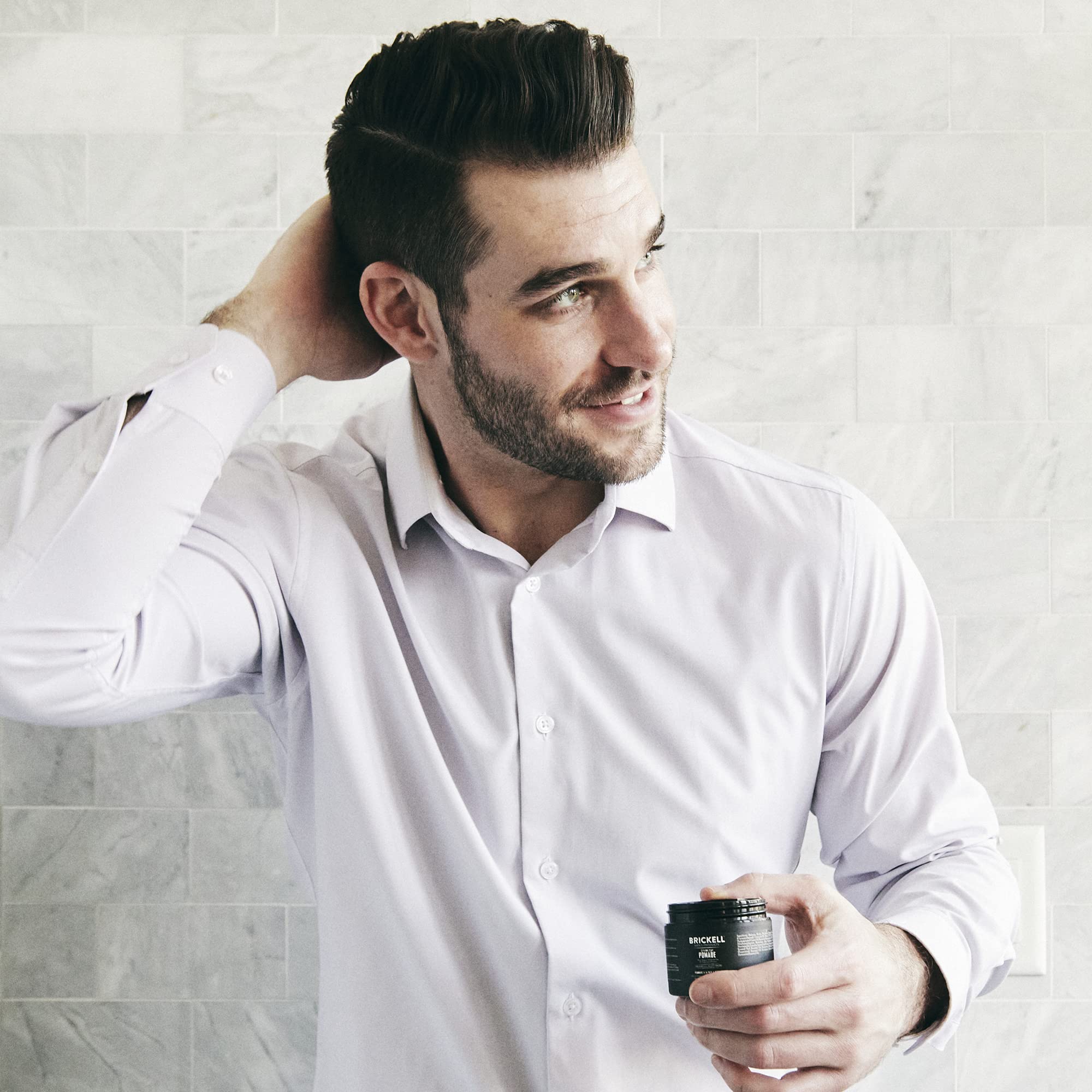 Brickell Men's hands applying paste demonstrating easy styling and flexible hold