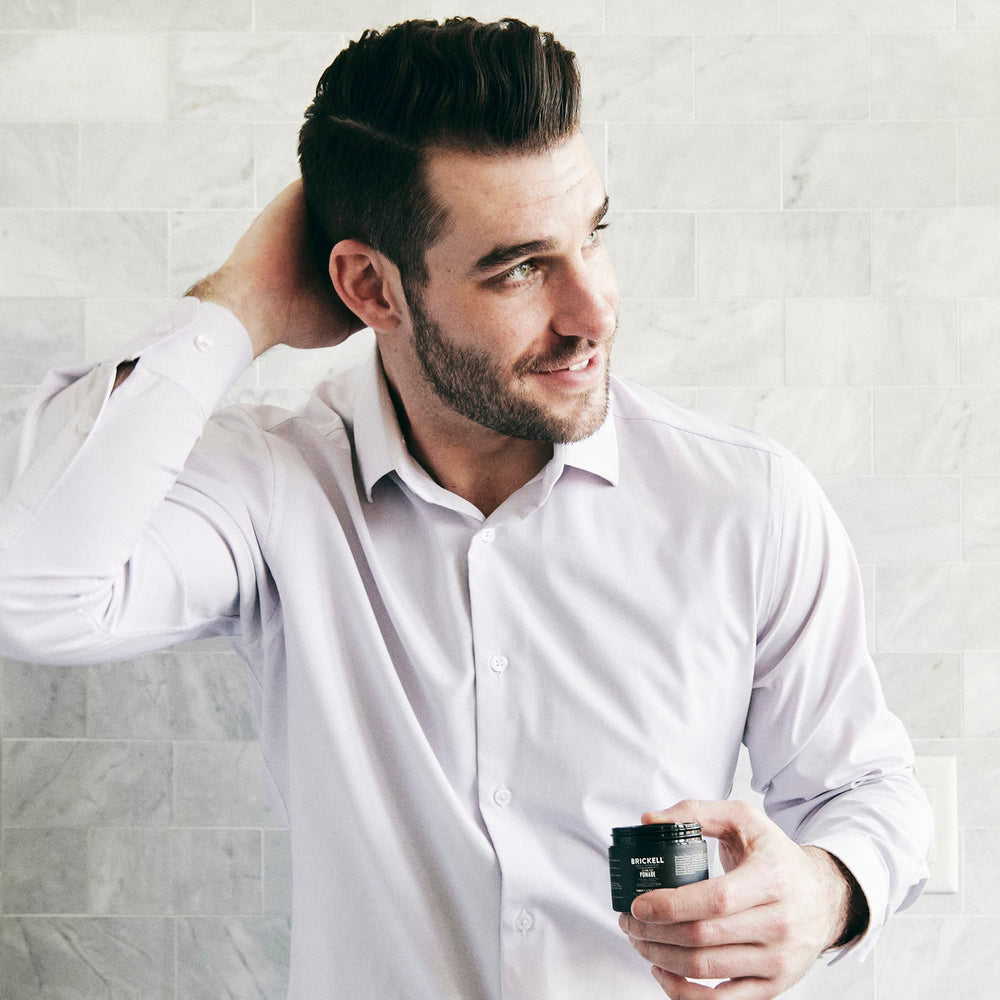 Brickell Men's hands applying paste demonstrating easy styling and flexible hold