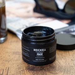 Applying Brickell pomade in hand demonstrating easy spread and control