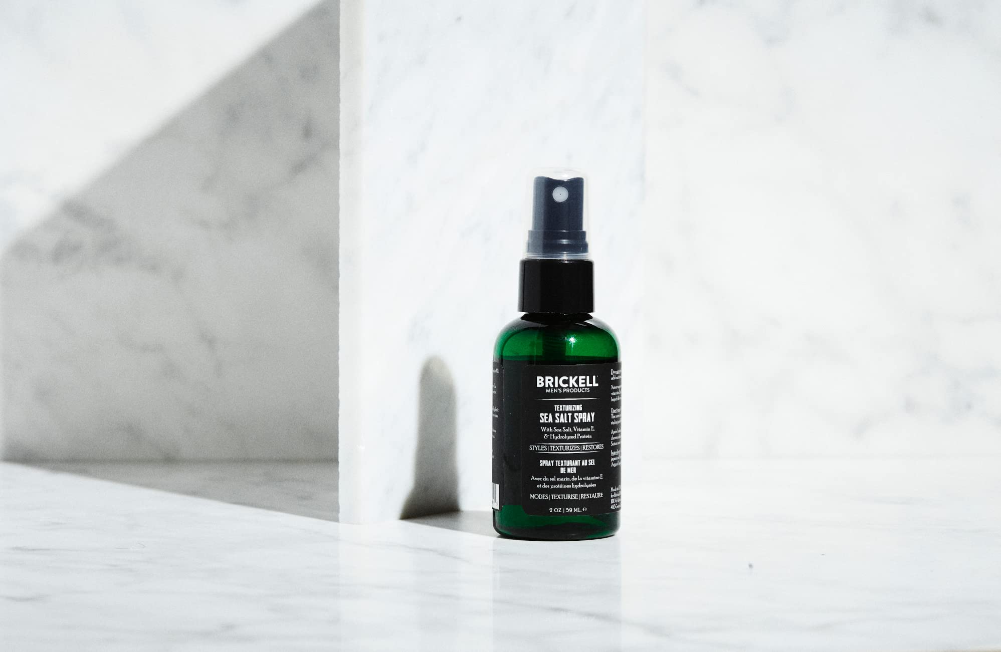 Brickell Men’s bottle next to ruler showing compact 2 ounce travel size