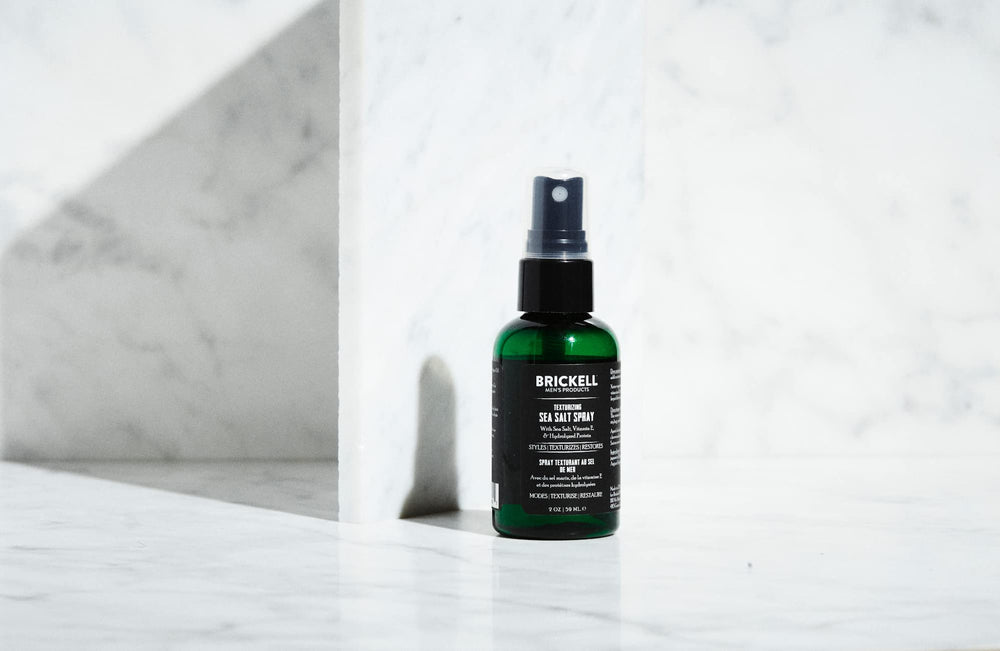Brickell Men’s bottle next to ruler showing compact 2 ounce travel size