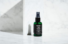 Brickell Men’s bottle next to ruler showing compact 2 ounce travel size