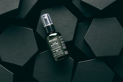 Brickell Men’s spray texture in hand demonstrating gritty, touchable hold