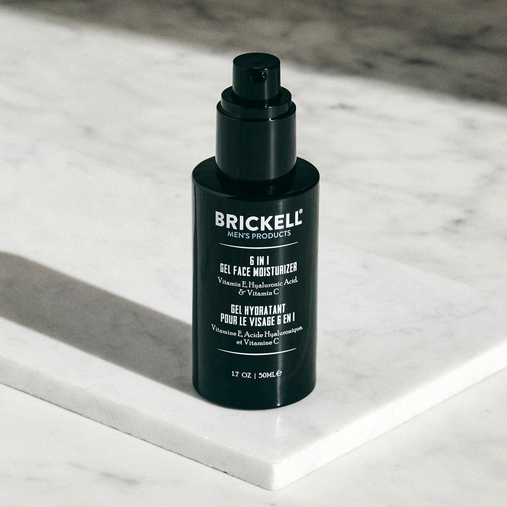 Brickell Men's 1.7 oz tube next to common items to show compact travel-friendly benefit