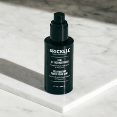 Brickell Men's 1.7 oz tube next to common items to show compact travel-friendly benefit