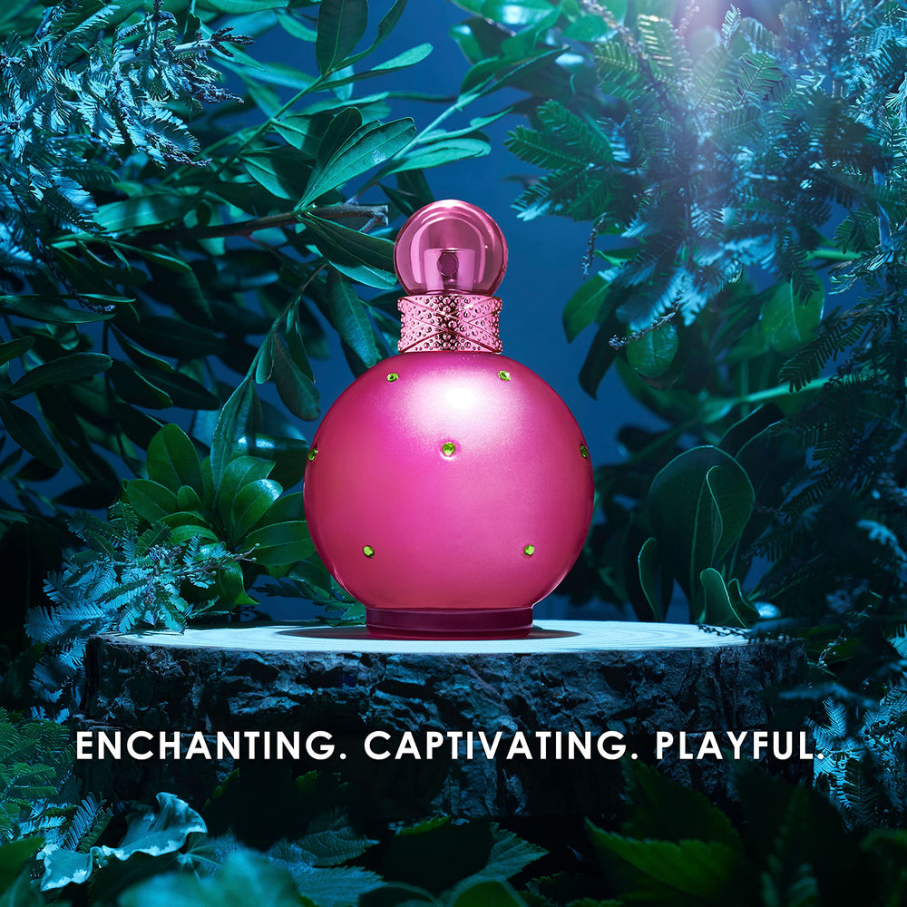 Britney Spears bottle beside common items to show compact travel-friendly size
