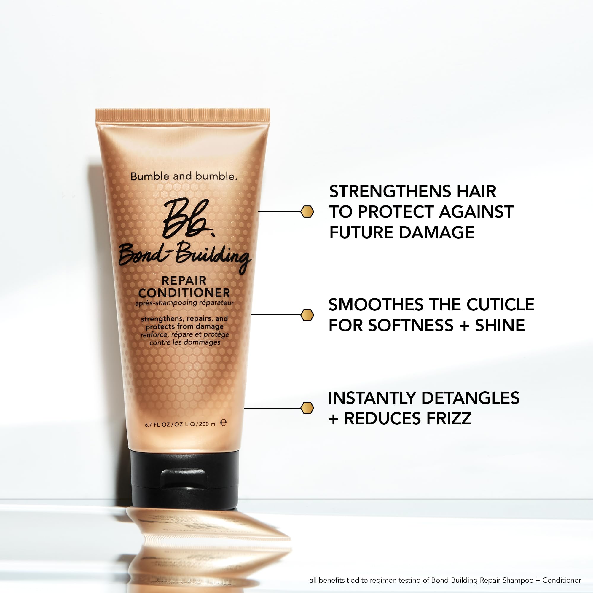 Bumble and bumble conditioner being smoothed into wet hair to detangle