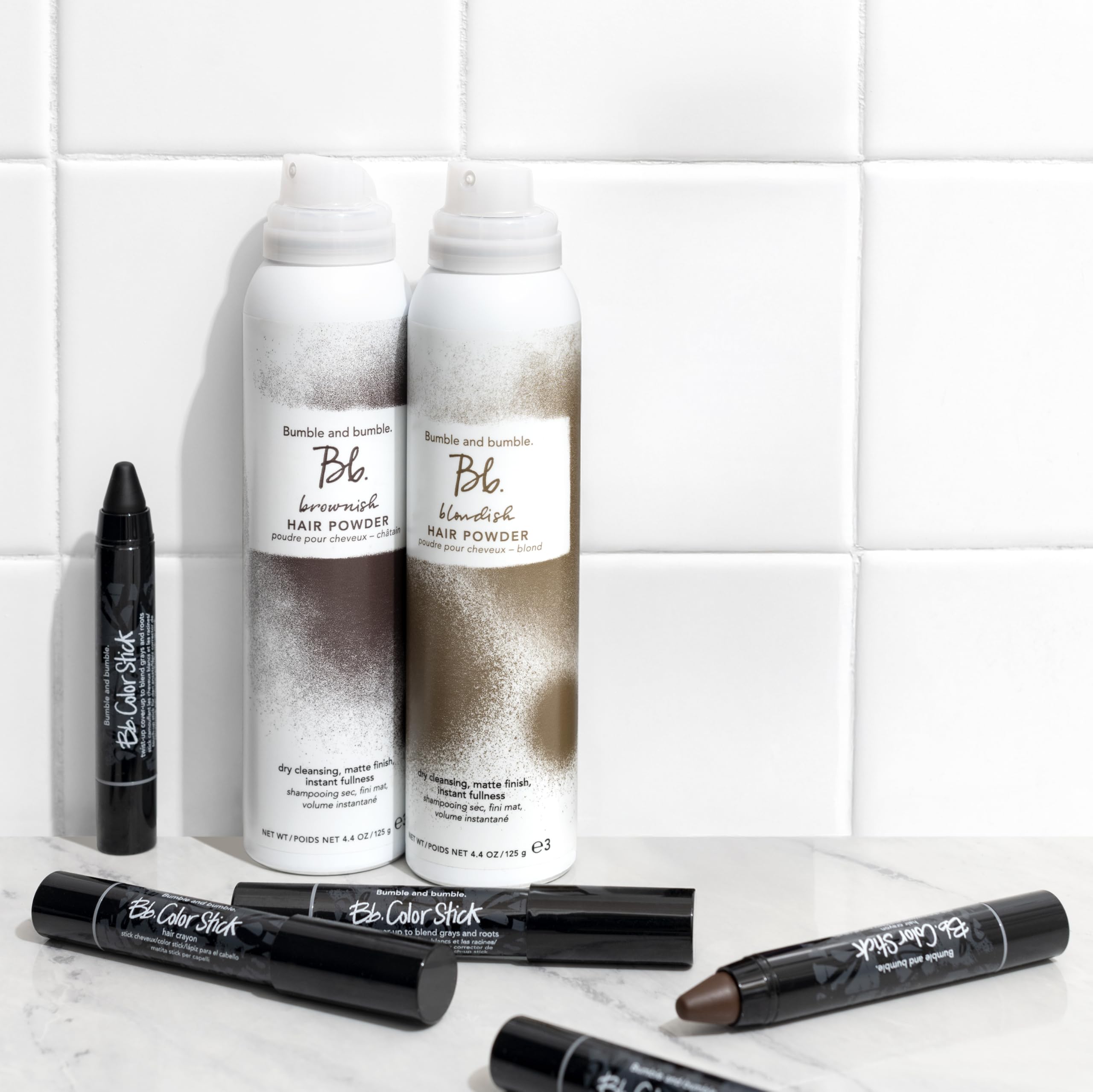 Bumble and bumble Color Stick inside a handbag showing convenience for on-the-go root camouflage
